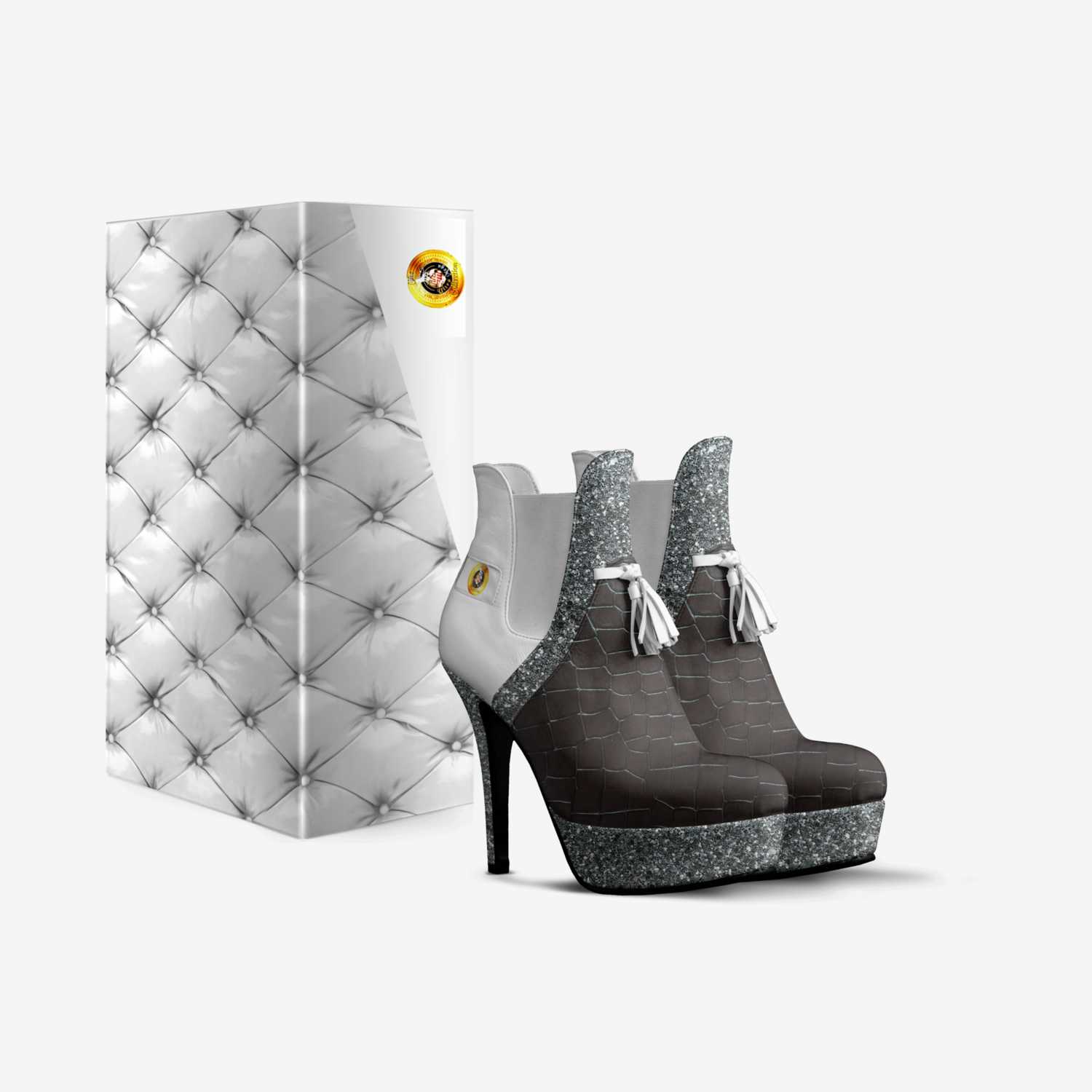 Stylish high-heeled shoes with a sparkling silver base and a black textured upper, presented beside an elegantly designed shoe box featuring a tufted pattern.